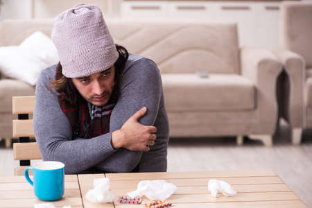 Young man suffering at homeの写真素材
