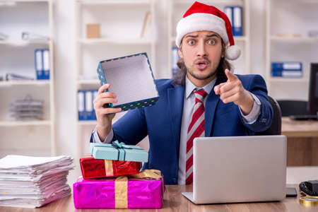 Young male employee working in the office at Christmas Eveの写真素材