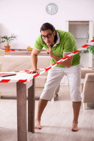 Young male student studying at home in self-isolation conceptの写真素材