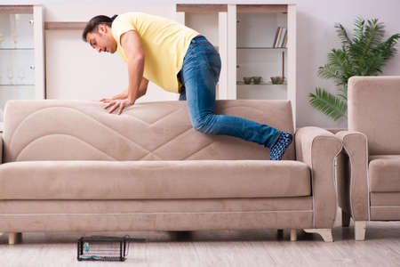 Young man and mousetrap at homeの写真素材