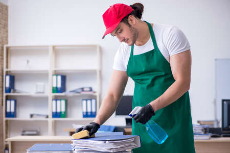 Young male contractor cleaning the office