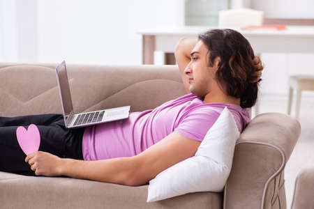 Male student in love preparing for exams at homeの写真素材