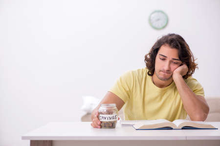 Young male student preparing for exams at home