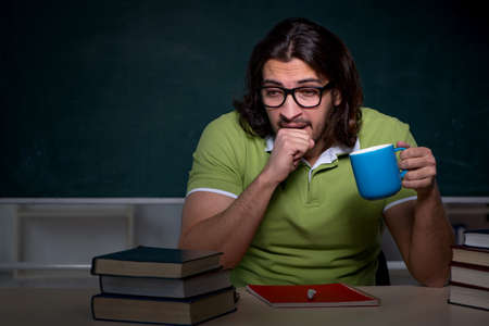 Young student studying at night at homeの写真素材