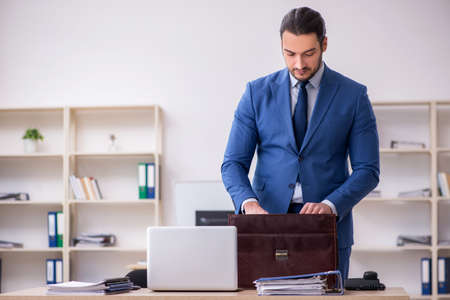 Young male businessman employee working in the officeの写真素材