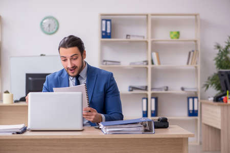 Young male businessman employee working in the officeの写真素材