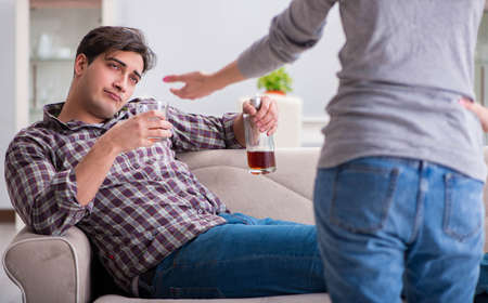 The drinking problem drunk husband man in a young family conceptの写真素材
