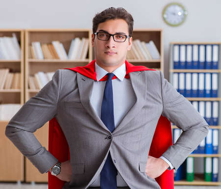 Superhero businessman working in the officeの写真素材