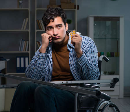 Man suffering from depression at wheelchairの写真素材