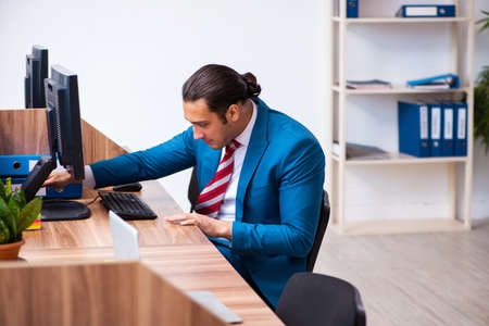 Young male employee working in the officeの写真素材