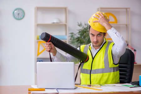 Young male architect working in the office
