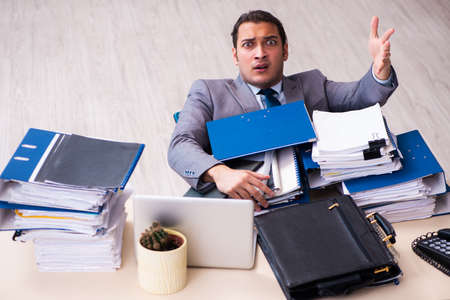 Young male employee unhappy with excessive work