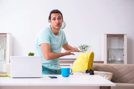 Young male parent looking after newborn at homeの写真素材