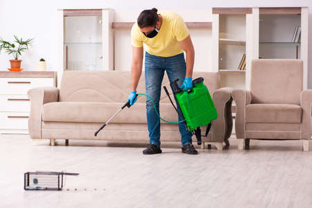 Young man and mousetrap at homeの写真素材