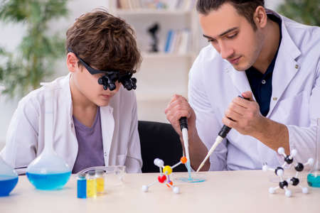 Young father and son chemists in the labの写真素材