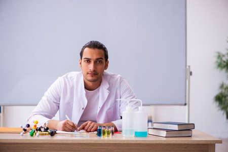 Young male chemistry teacher in the classroomの写真素材