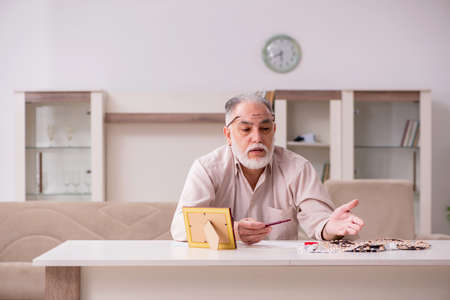 Old sick man suffering at homeの写真素材