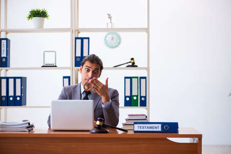 Young male lawyer sitting in the officeの写真素材