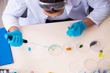 Young male chemist perfumer working in the lab