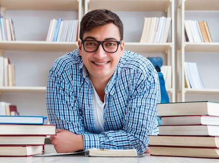 Young student studying with booksの写真素材