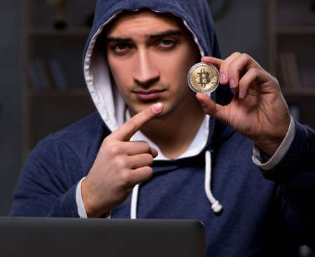 Young man in bitcoin mining conceptの写真素材