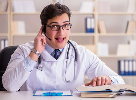 Young man doctor in medical conceptの写真素材