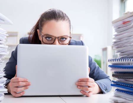 Tired businesswoman with paperwork workload