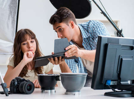 Young photographer working in photo studioの写真素材