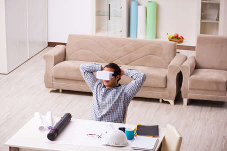 Young male architect working from house during pandemicの写真素材