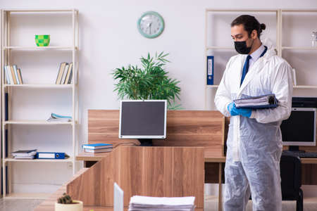 Young male employee in self-isolation conceptの写真素材