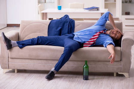 Young male employee being fired from his work at homeの写真素材