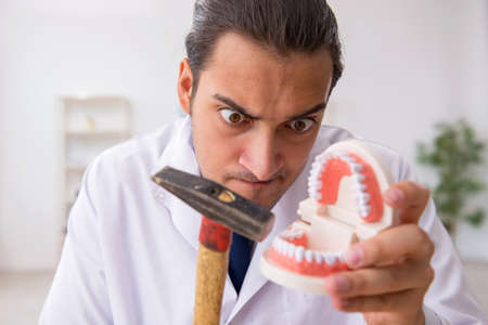 Young male doctor stomatologist working in the clinic