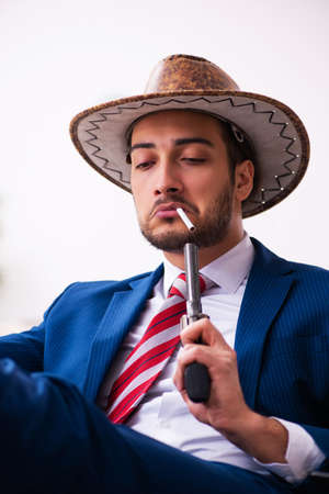 Young businessman cowboy working in the officeの写真素材