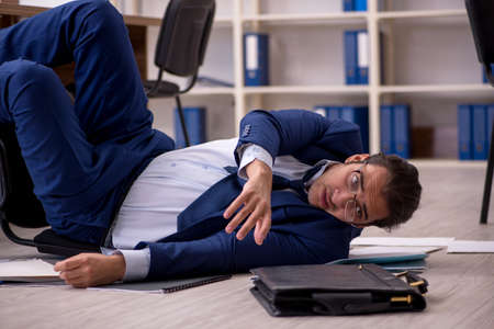 Young male businessman employee unhappy with his workの写真素材