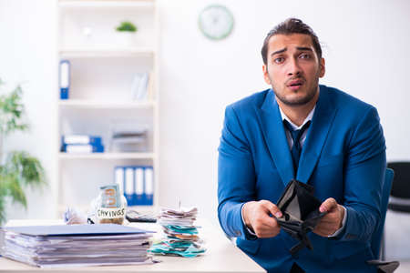 Young male accountant in budget planning concept