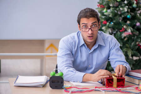 Young male teacher celebrating new year at schoolの写真素材