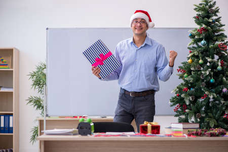Young male teacher celebrating new year at schoolの写真素材
