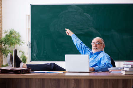 Old male teacher in tele-education conceptの写真素材