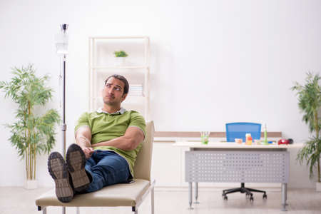 Young male patient in blood transfusion conceptの写真素材