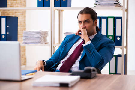 Young male employee working in the officeの写真素材