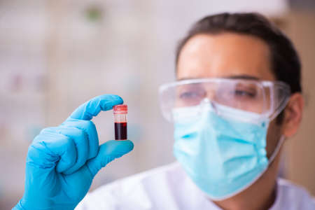 Young male chemist working in the lab