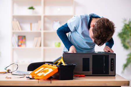 Boy reparing computers at workshopの写真素材