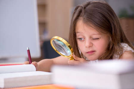 Small girl preparing for exams at homeの写真素材