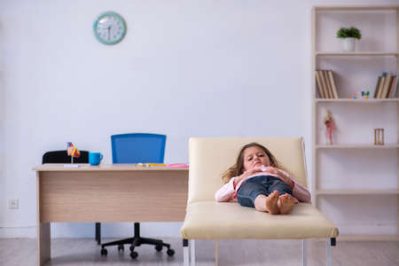 Small girl waiting for doctor in the clinicの写真素材