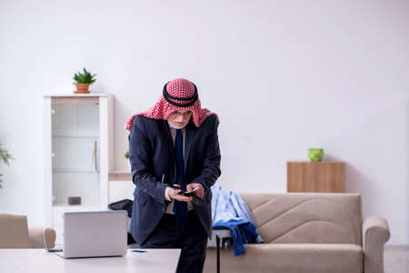 Old arab businessman preparing for business tripの写真素材