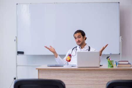 Young male doctor giving seminar in the classroomの写真素材