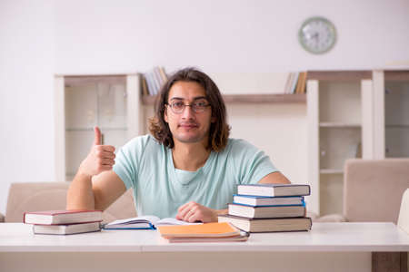 Young male student preparing for exams at homeの写真素材