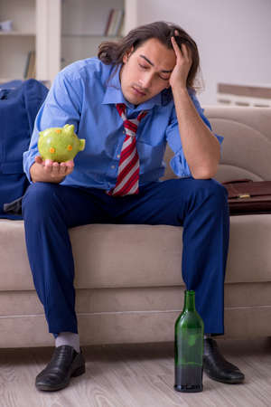 Young male employee being fired from his work at homeの写真素材