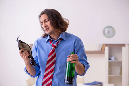 Young male employee being fired from his work at homeの写真素材