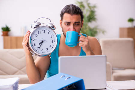 Young man working from house during pandemic